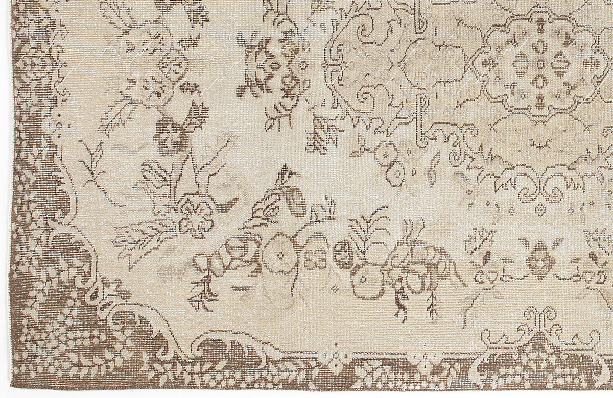 Beige and brown rug with a distressed traditional floral medallion pattern.