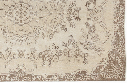 Load image 1 in gallery view. Beige and brown vintage-style rug with a distressed floral medallion pattern and ornate border.