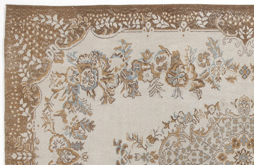 Load image 1 in gallery view. Beige and brown distressed rug with a floral medallion pattern and light blue accents.