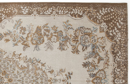 Load image 1 in gallery view. Beige and brown traditional rug with a distressed floral medallion pattern and blue accents.