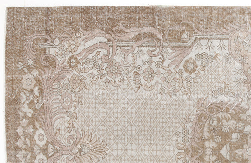Load image 1 in gallery view. Distressed beige and cream rug with a traditional floral medallion pattern and a geometric lattice border.