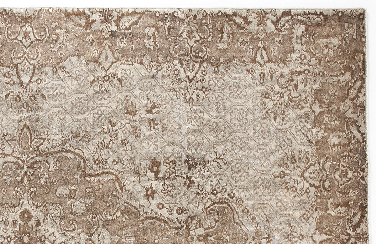 Taupe and beige rug with a distressed traditional medallion pattern and a subtle geometric honeycomb overlay.