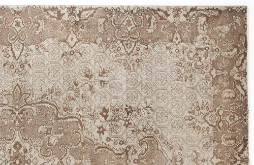 Load image 1 in gallery view. Taupe and beige rug with a distressed traditional medallion pattern and a subtle geometric honeycomb overlay.