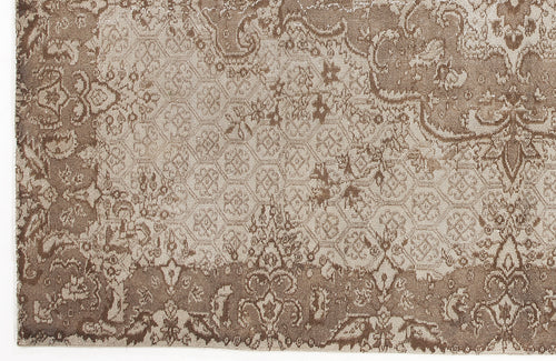 Load image 1 in gallery view. Taupe and beige rug with a distressed traditional floral medallion pattern and a geometric honeycomb center.
