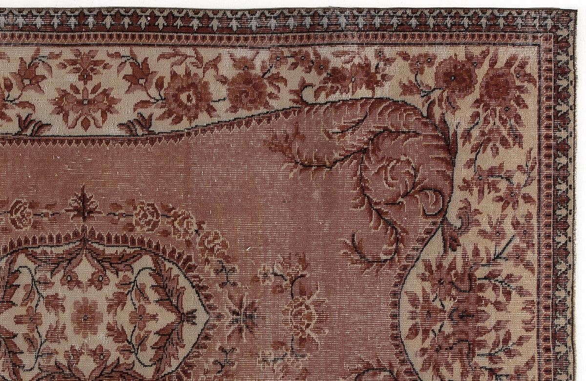 Terracotta and beige traditional rug with a floral medallion pattern and intricate border.