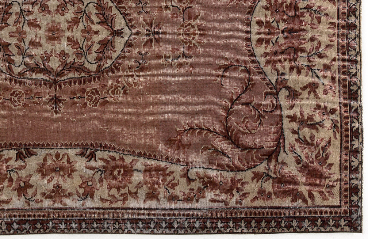 Terracotta and beige traditional rug with a floral medallion pattern and a detailed geometric border.