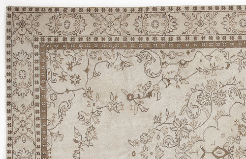 Load image 1 in gallery view. Beige and brown traditional rug with a floral vine pattern and a decorative border.