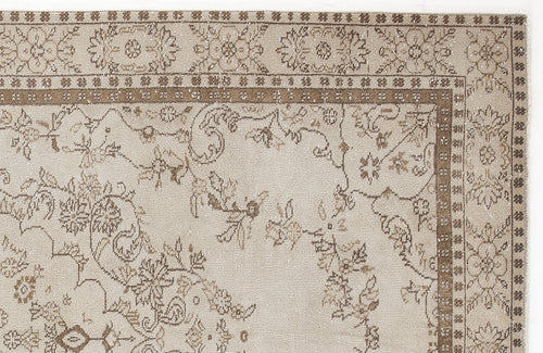 Load image 1 in gallery view. Beige and brown rug with a traditional floral border and central vine motif on a white background.