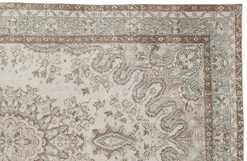 Load image 1 in gallery view. Distressed traditional rug in cream, sage green, and brown with a floral medallion pattern and ornate border.