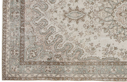 Load image 1 in gallery view. Distressed beige, brown, and sage green rug with a traditional ornate medallion pattern and a detailed geometric border.