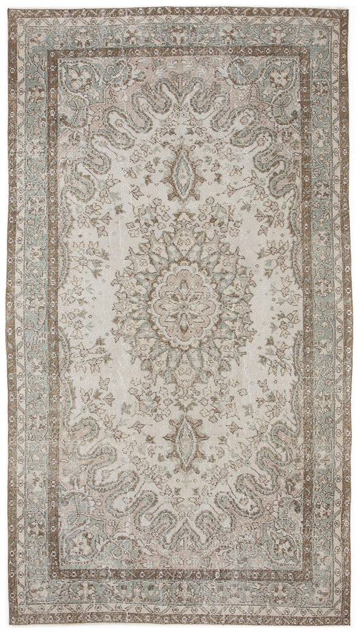 Load image 1 in gallery view. Distressed beige, sage green, and brown rug with a central floral medallion and ornate border on a white background.