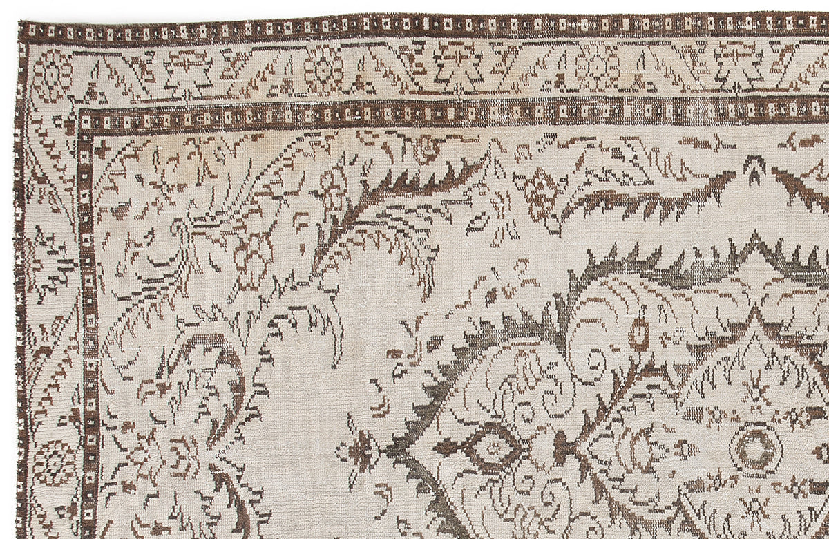 Beige and brown traditional rug with a detailed floral medallion pattern and geometric border.