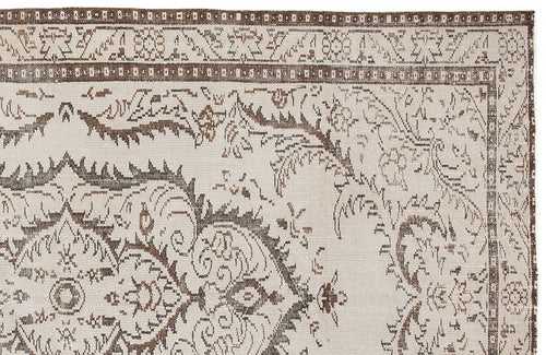 Load image 1 in gallery view. Beige and brown traditional rug with a distressed floral medallion pattern and a geometric border.