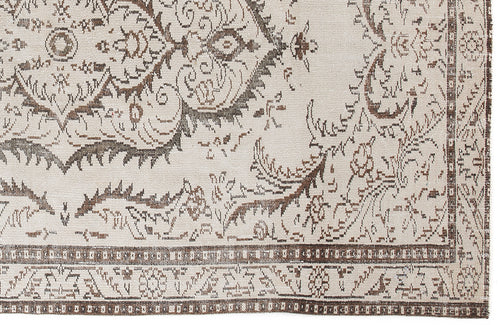 Load image 1 in gallery view. Cream and brown rug with a distressed traditional floral medallion pattern and a geometric border.