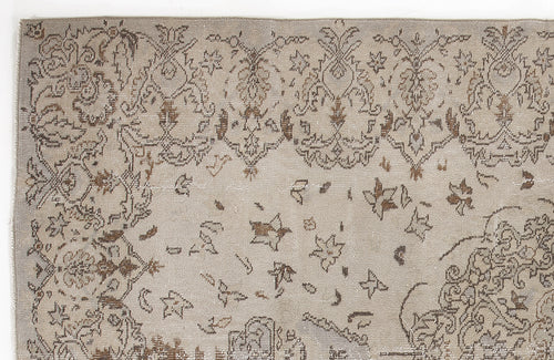 Load image 1 in gallery view. Taupe and brown vintage-style rug with a distressed floral medallion pattern on a white background.