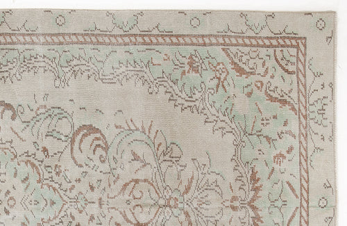 Load image 1 in gallery view. Beige, sage green, and terracotta distressed rug with a traditional floral medallion pattern and a rope-style border.