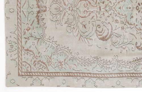 Load image 1 in gallery view. Beige and sage green rug with a distressed traditional floral medallion pattern and a rope-style border.