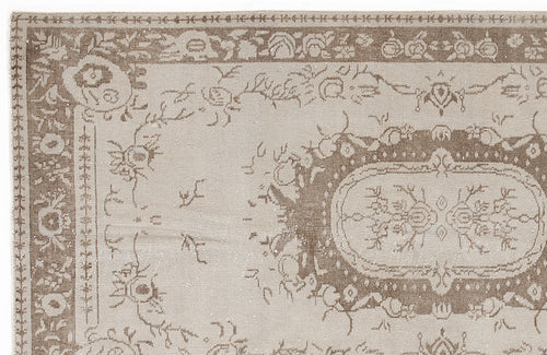 Load image 1 in gallery view. Taupe and beige traditional rug with a distressed floral medallion pattern and ornate border.