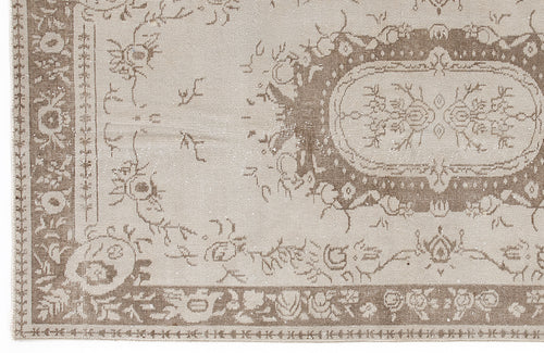 Load image 1 in gallery view. Beige and taupe vintage-style rug with a distressed floral medallion pattern and ornate border.