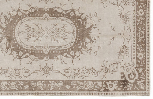 Load image 1 in gallery view. Beige and taupe vintage-style rug with a distressed floral medallion pattern and a decorative border.