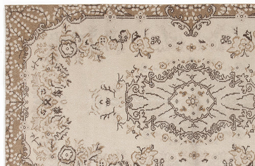 Load image 1 in gallery view. Beige and brown rug with a distressed traditional floral medallion pattern and ornate border.
