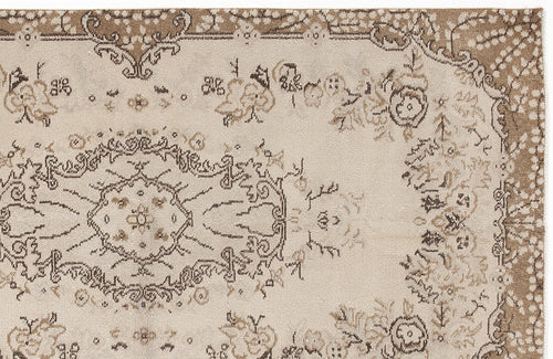 Load image 1 in gallery view. Beige and brown traditional rug with a central floral medallion and ornate border pattern.