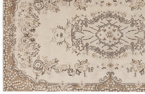 Load image 1 in gallery view. Beige and taupe traditional rug with a distressed floral medallion pattern and ornate border.