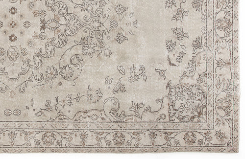 Load image 1 in gallery view. Beige and taupe distressed rug with a faded traditional floral medallion pattern and a decorative border.