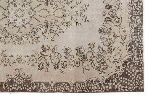 Load image 1 in gallery view. Taupe and dark brown rug with a traditional floral medallion pattern and a decorative border.