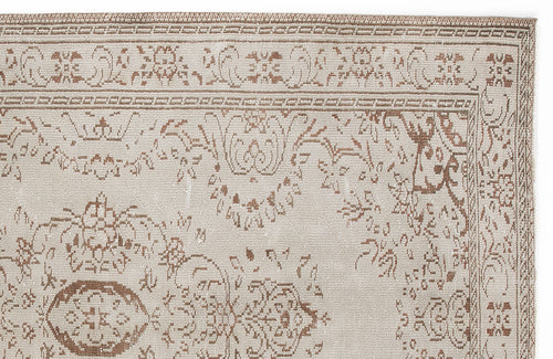 Load image 1 in gallery view. Beige and brown rug with a traditional floral medallion pattern and a decorative border on a white background.