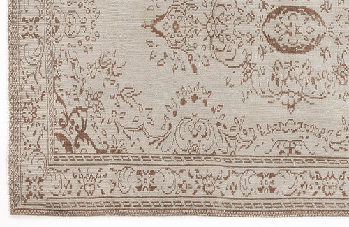 Load image 1 in gallery view. Beige and brown rug with a traditional distressed floral medallion pattern and a geometric border.