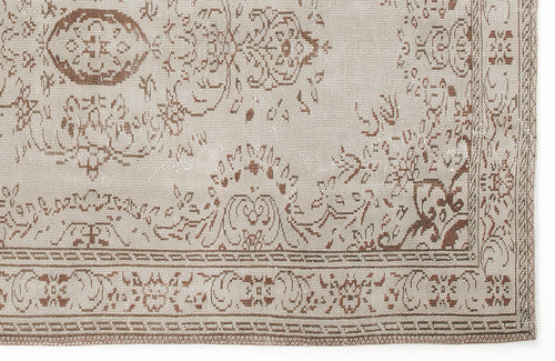 Load image 1 in gallery view. Beige and brown rug with a distressed traditional floral medallion pattern and a geometric border.