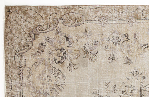 Load image 1 in gallery view. Beige and taupe vintage-style rug with a distressed floral medallion pattern on a white background.