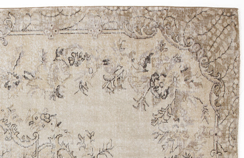 Load image 1 in gallery view. Beige and taupe distressed rug with a faded floral medallion pattern and intricate border detail.