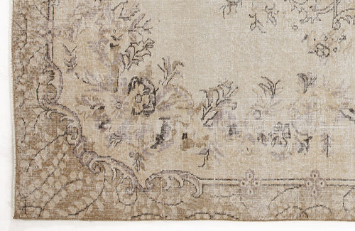 Load image 1 in gallery view. Beige and taupe distressed rug with a faded floral medallion pattern and intricate border detail.