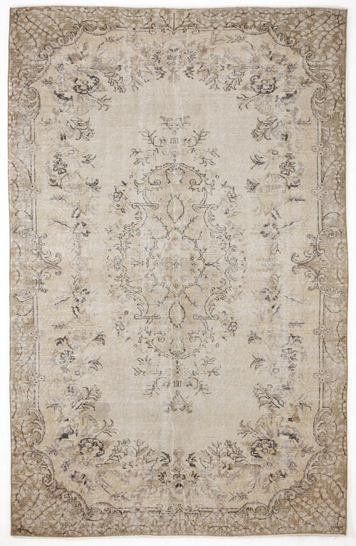 Load image 1 in gallery view. Beige and taupe distressed rug with a central floral medallion and ornate border pattern.