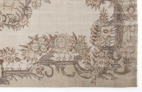Load image 1 in gallery view. Beige and taupe vintage-style rug with a distressed floral border pattern on a white background.