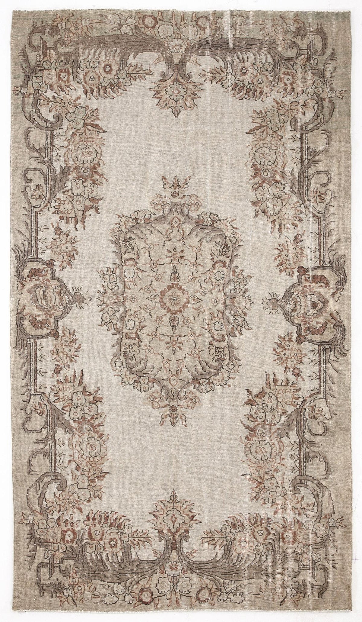 Beige vintage-style rug with a central floral medallion and ornate botanical border in muted brown and terracotta tones.