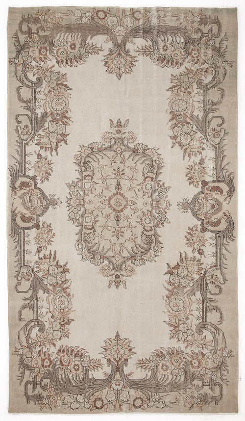 Load image 1 in gallery view. Beige vintage-style rug with a central floral medallion and ornate botanical border in muted brown and terracotta tones.