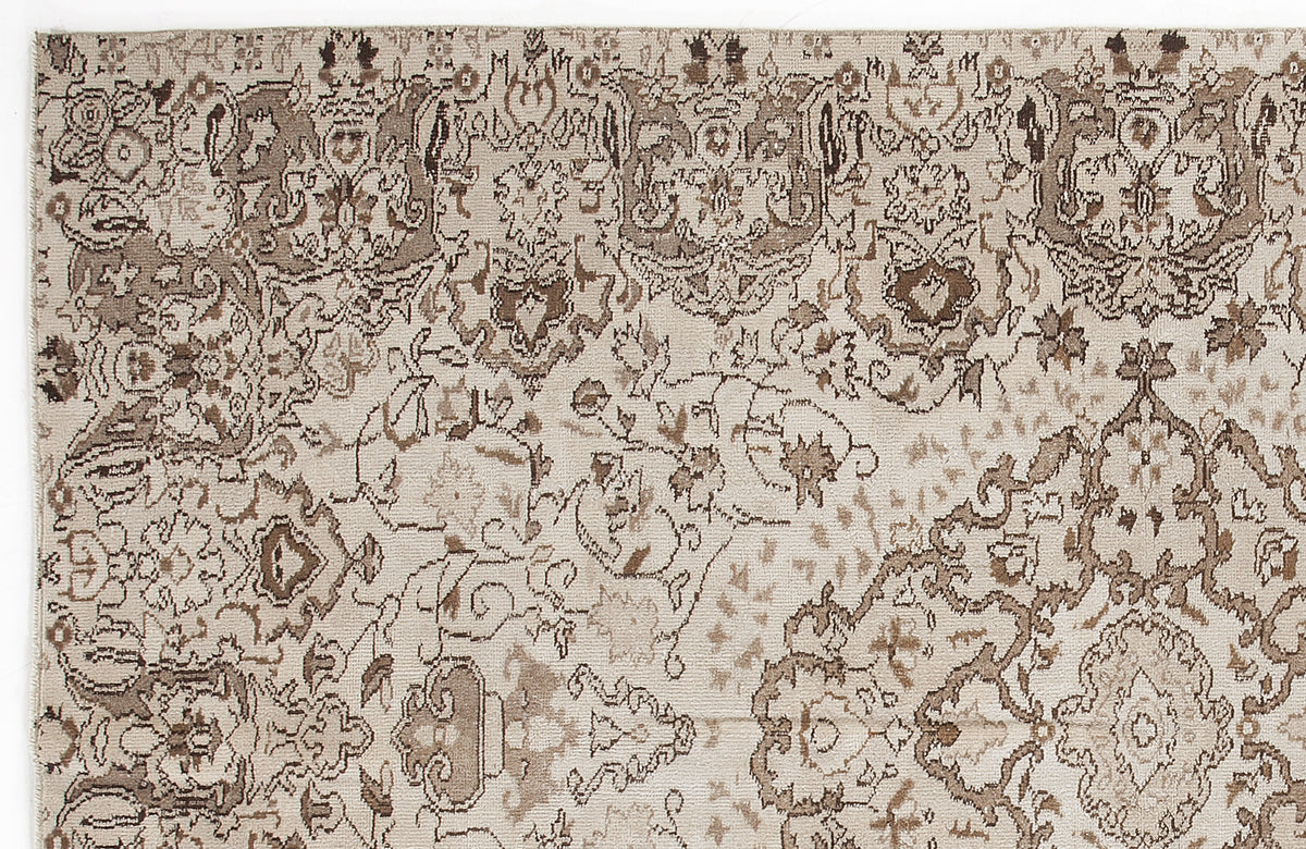 Beige and brown rug with a distressed, traditional floral medallion pattern.