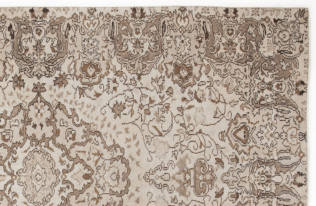 Beige and brown rug with a distressed, traditional floral medallion pattern.