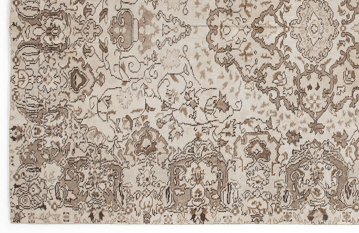 Beige and taupe rug with a distressed, traditional Persian-style floral medallion pattern.