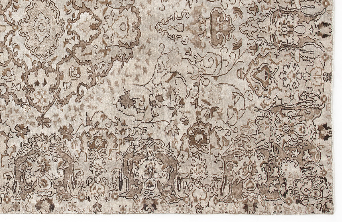 Beige and brown rug with a distressed, traditional floral medallion pattern.
