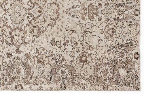 Load image 1 in gallery view. Beige and brown rug with a distressed, traditional floral medallion pattern.