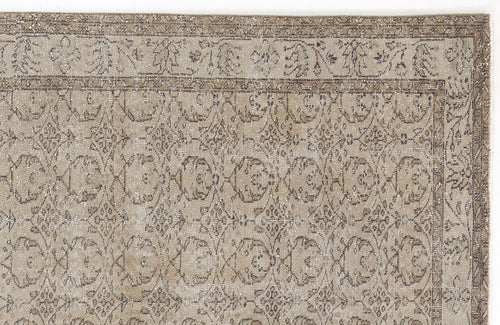 Load image 1 in gallery view. Beige and taupe vintage-style rug with a distressed floral medallion pattern and a decorative border.