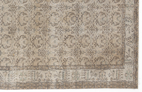 Load image 1 in gallery view. Beige and taupe vintage-style rug with a distressed floral medallion pattern and a decorative border.