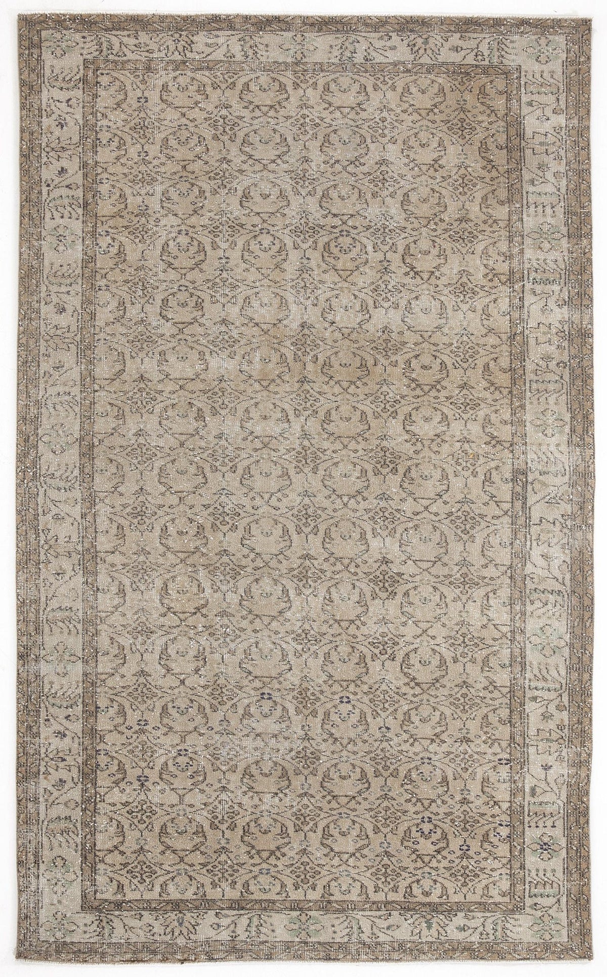 Beige and grey distressed rug with a repeating geometric medallion pattern and a wide decorative border.