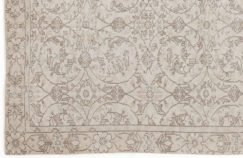 Load image 1 in gallery view. Beige and taupe rug with a traditional floral medallion pattern and a decorative border.