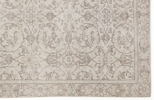Load image 1 in gallery view. Beige and taupe traditional rug with a distressed floral medallion pattern and a decorative border.