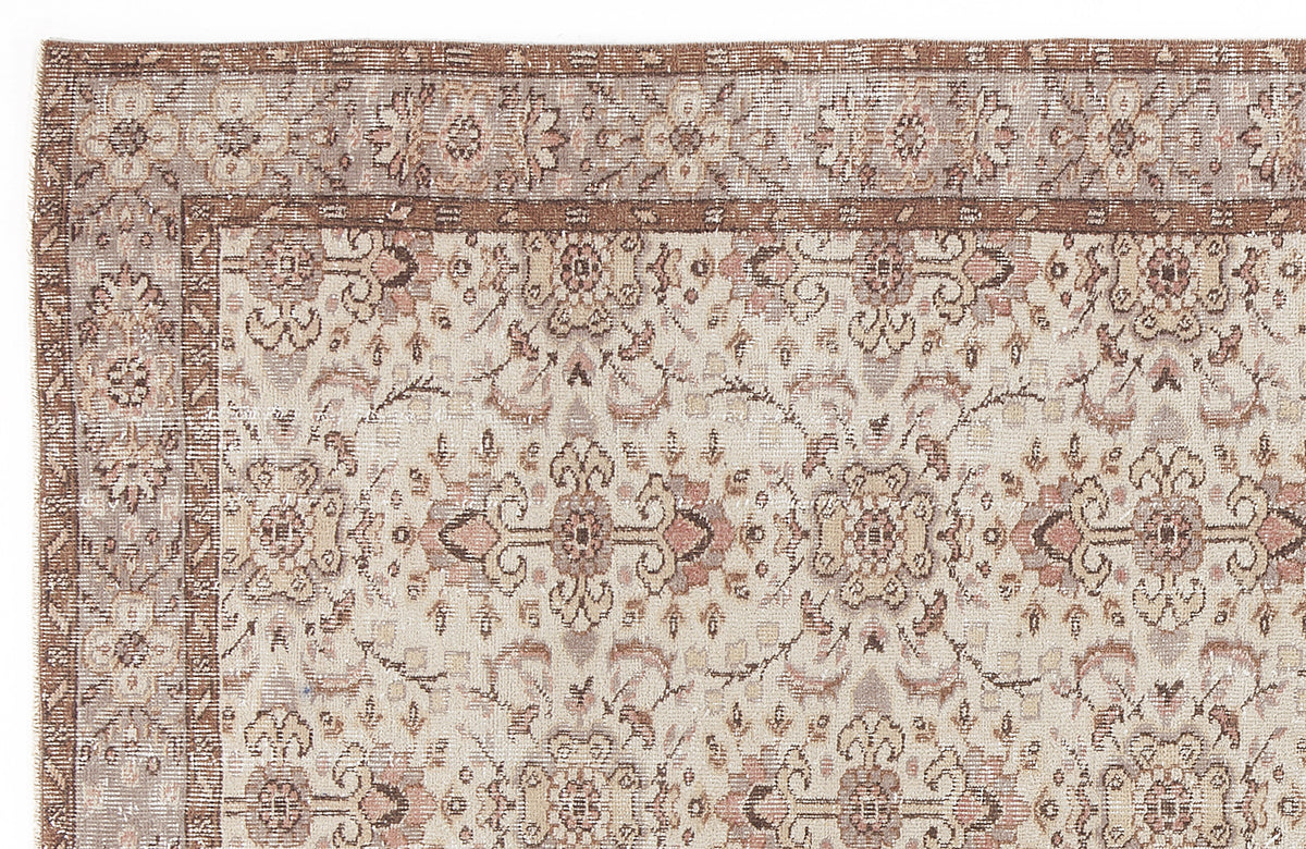 Distressed beige and brown traditional rug with a faded floral medallion pattern and a wide decorative border.